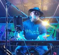 Roy performing with blue stage lighting